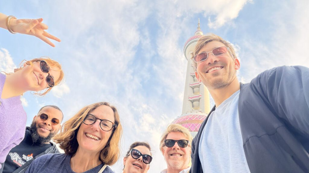 Members of the 2025 Heartland Leaders Delegation pose for a photo in front of the Pearl Tower in Shanghai.